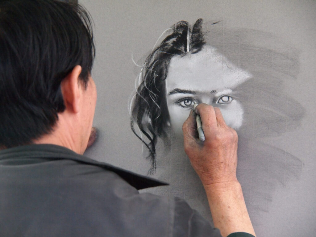 A man drawing a face